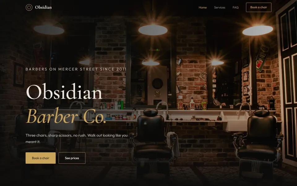 Obsidian Barber Co. homepage: barbershop interior with the shop name in gold